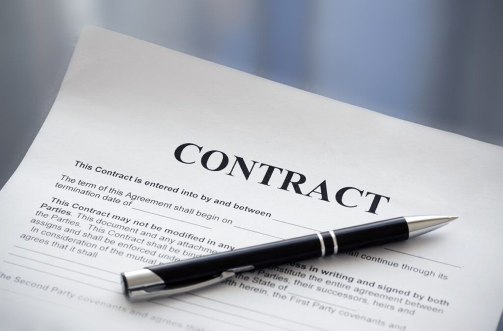 Contract document with a pen on top.