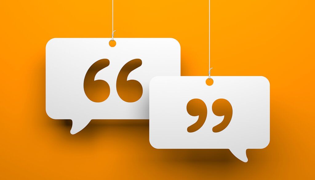 Two white quotation marks hang against an orange background.