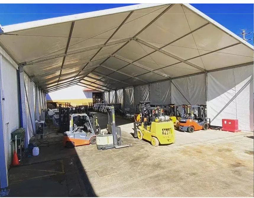 Large construction tent rental providing weather protection, secure storage, and work space at a Houston construction site.