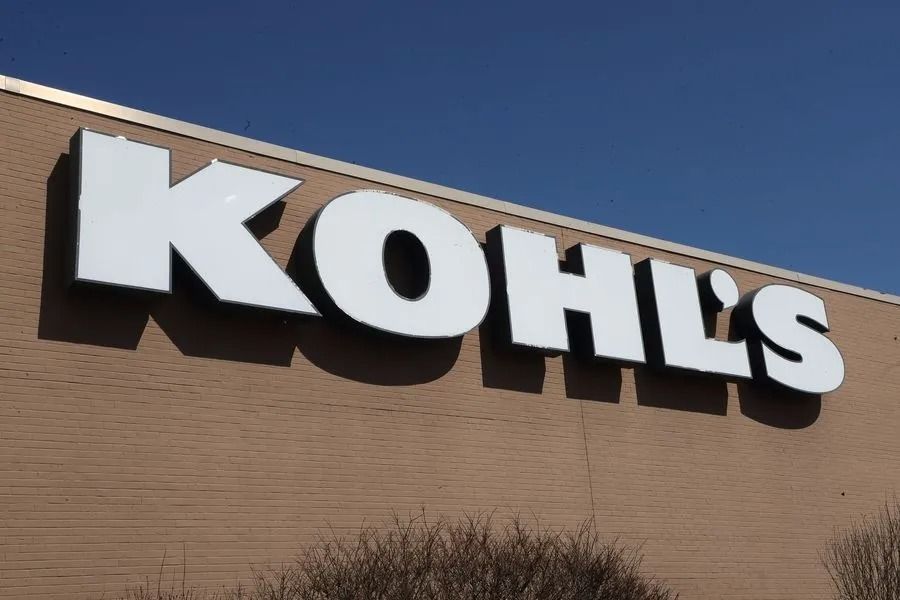 Kohl’s storefront sign on a tan building against a blue sky