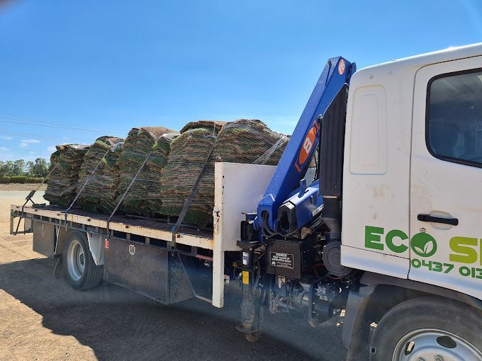 Truck Carrying a Load of Rocks on a Trailer at a Sunny Roadside Construction Site — Eco Skips In Midge Point, QLD