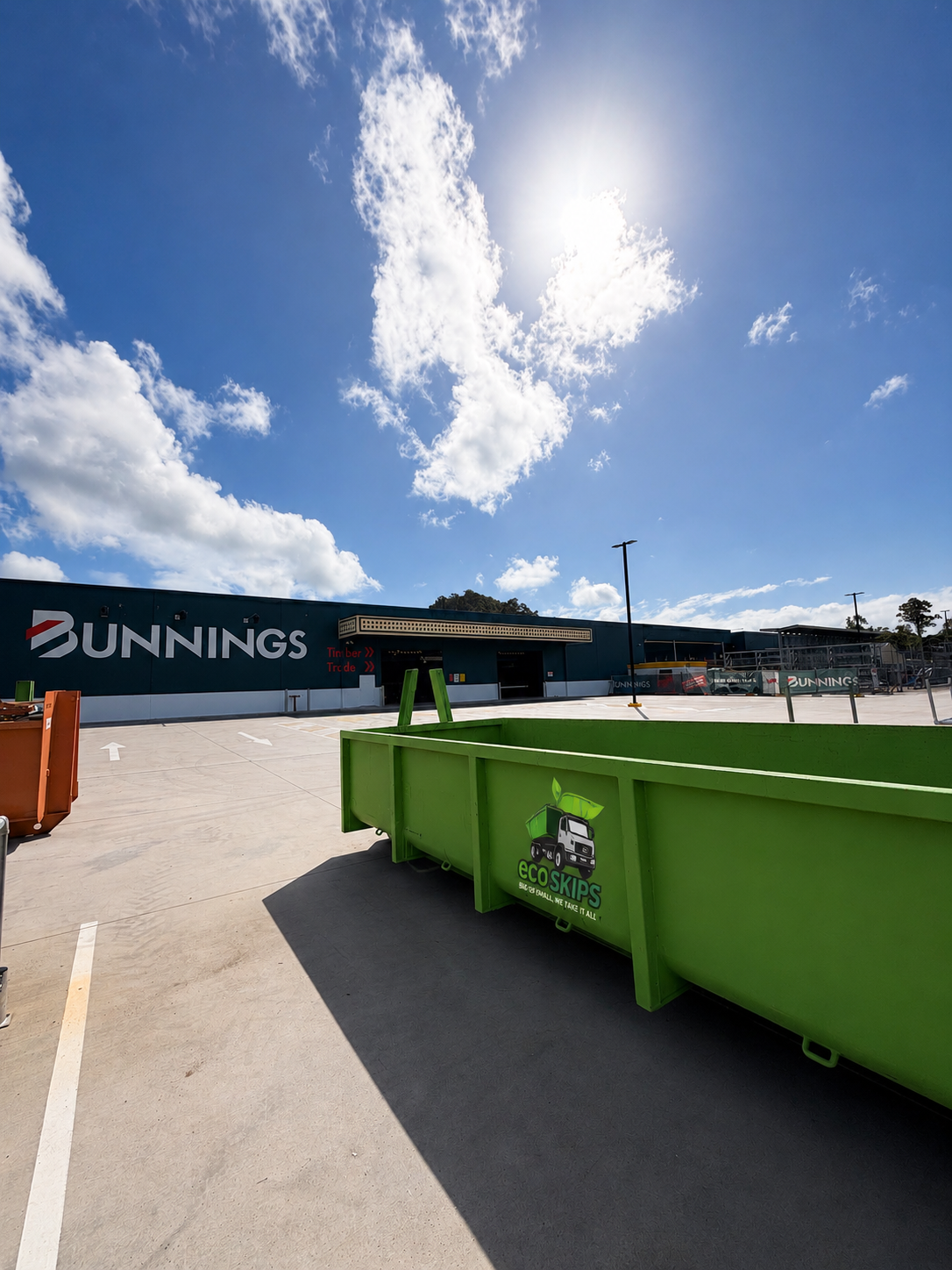 Bunnings Parking Lot With Bright Green Skip Bins Under a Sunny Blue Sky — Eco Skips In Midge Point, QLD