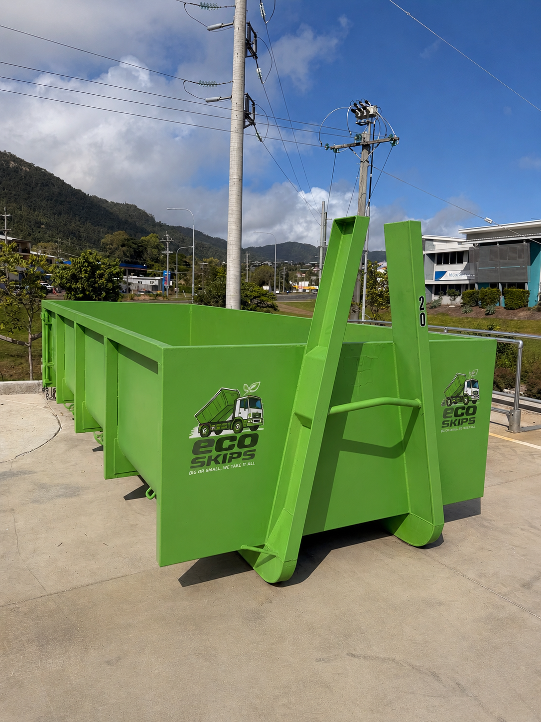 Bright Green Construction Dumpster on a Concrete Road — Eco Skips In Bloomsbury, QLD