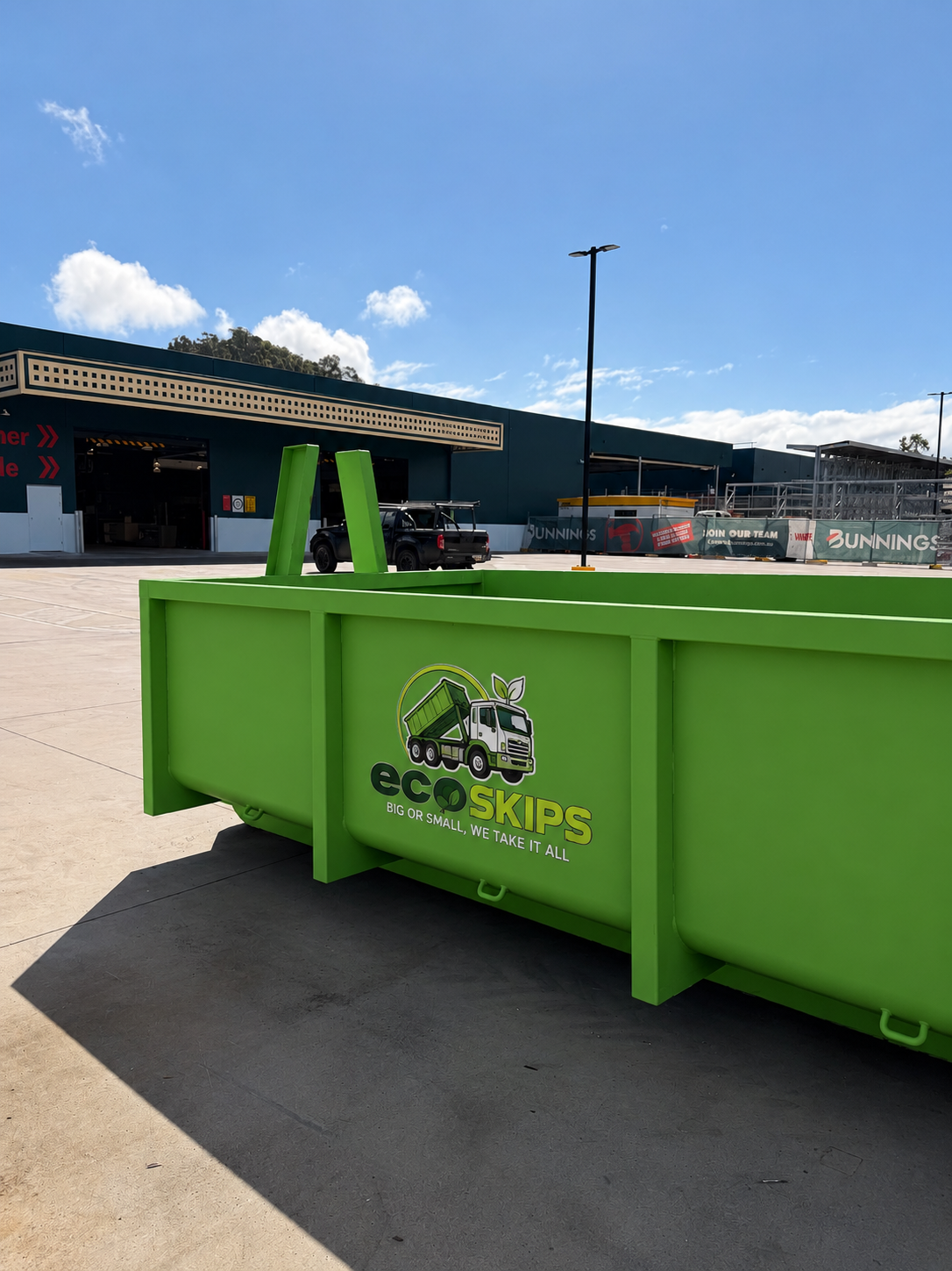 Bright Green Eco Skips Dumpster in an Industrial Parking Lot — Eco Skips In Cannonvale, QLD