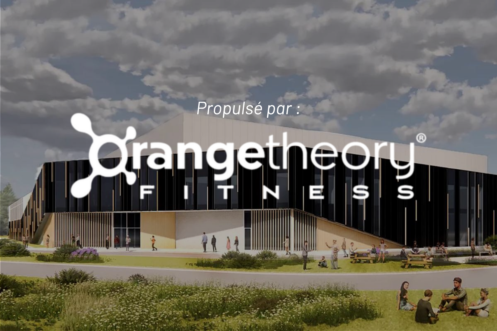 Orangetheory Fitness storefront in a modern building with people outside under a cloudy sky