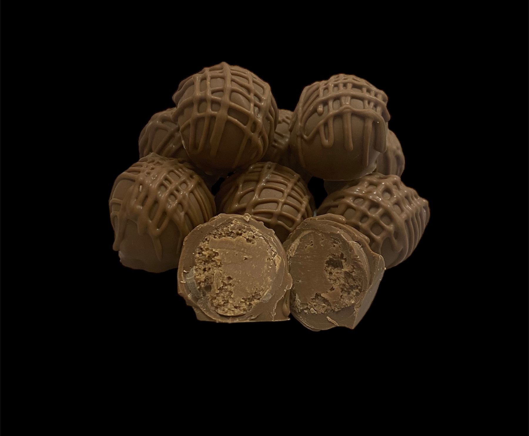 Tray of white coconut-covered dessert balls arranged tightly in a circular pan