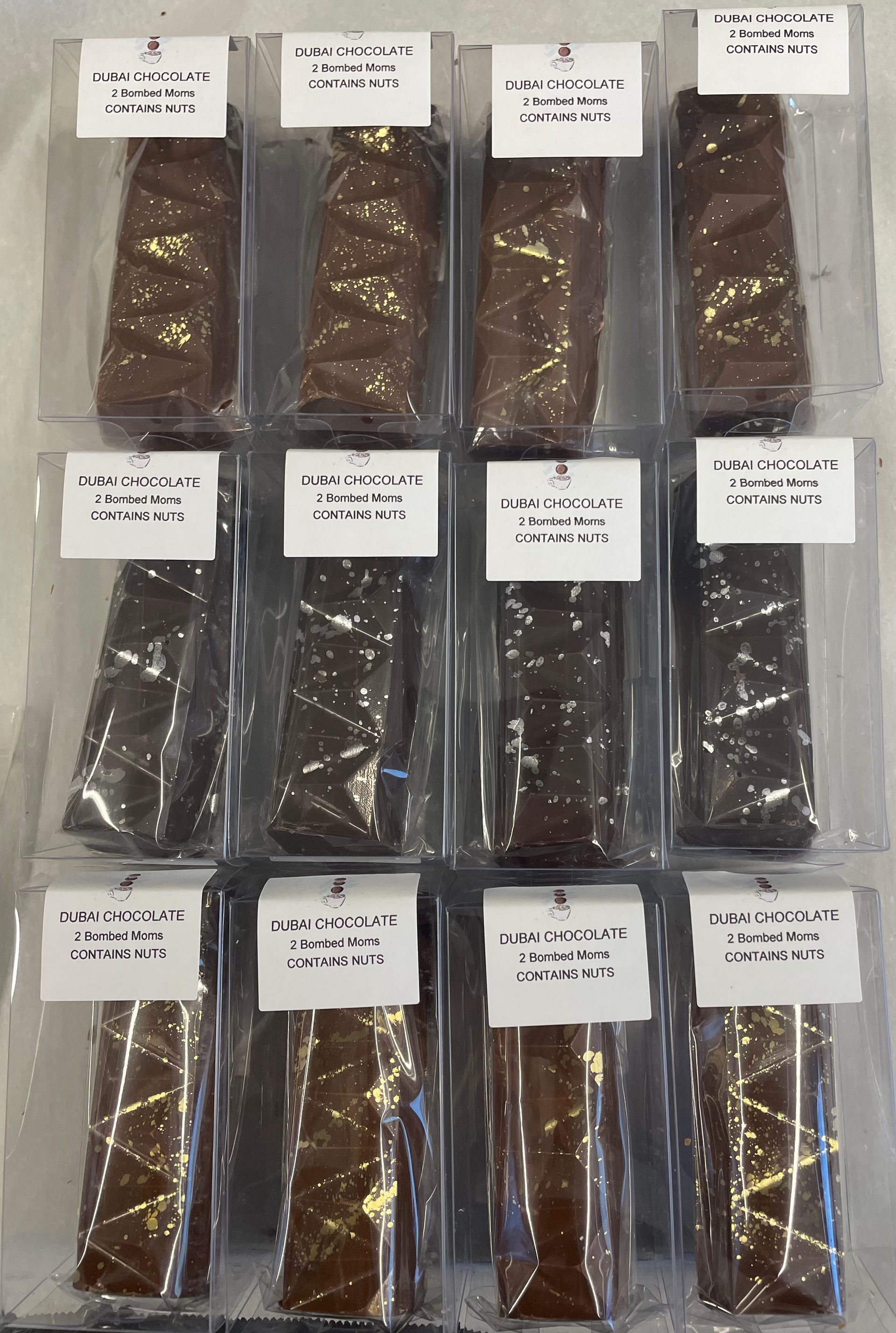 Rows of labeled packaged brown strips arranged on a white surface