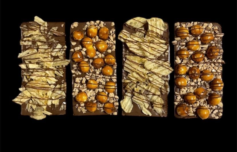 Four vertical close-up strips of dried nuts or seeds on a black background