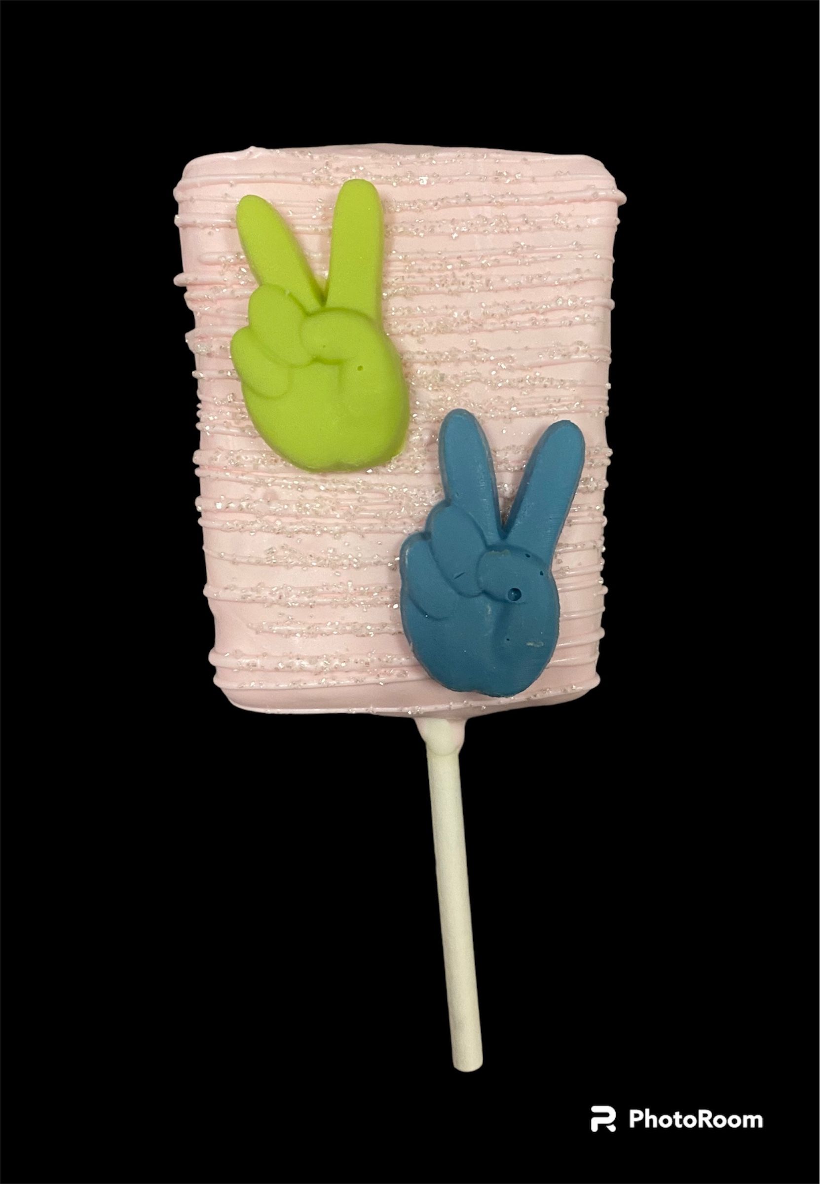 Four pink popsicles with gold crosses on sticks against a black background