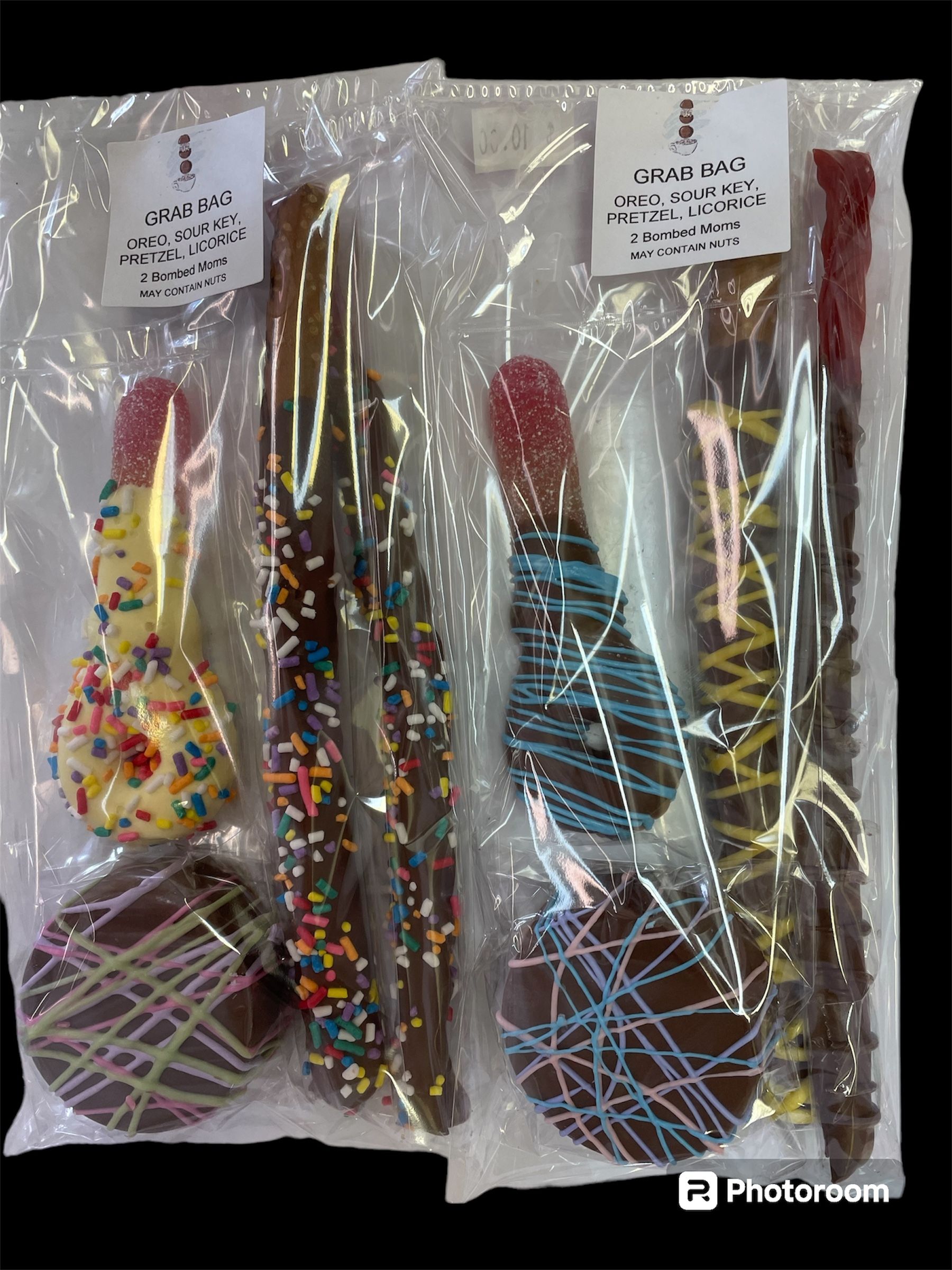 Chocolate-covered mini sour keys in brown and pink, arranged on a black background with the label above.