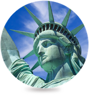 The statue of liberty is in a circle with a blue sky in the background.