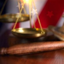 A pair of scales of justice sitting on top of a wooden table.