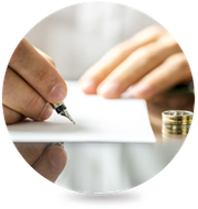 A person is writing on a piece of paper with a pen.