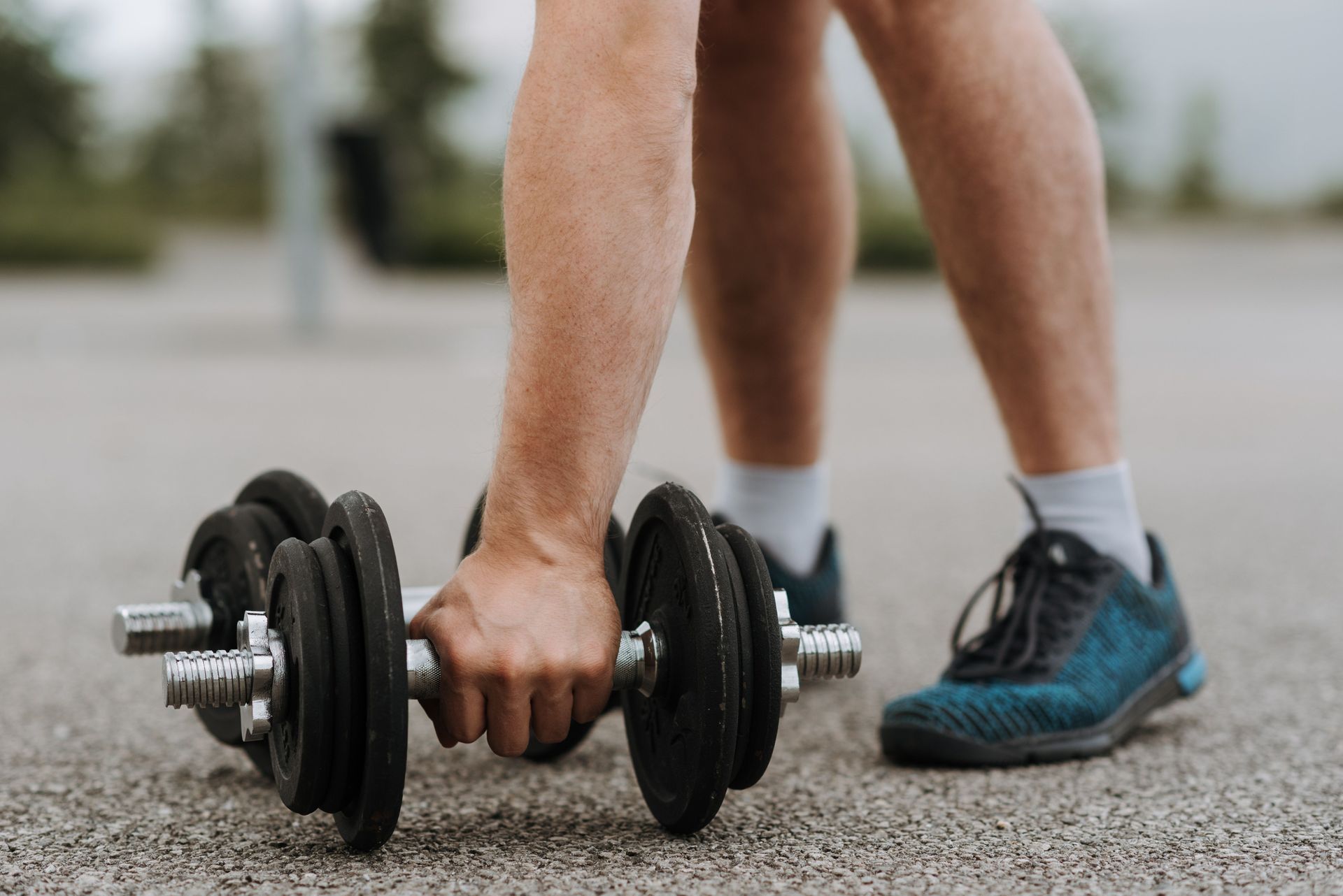 Woman lifting weights while undergoing GLP-1 weight loss treatment
