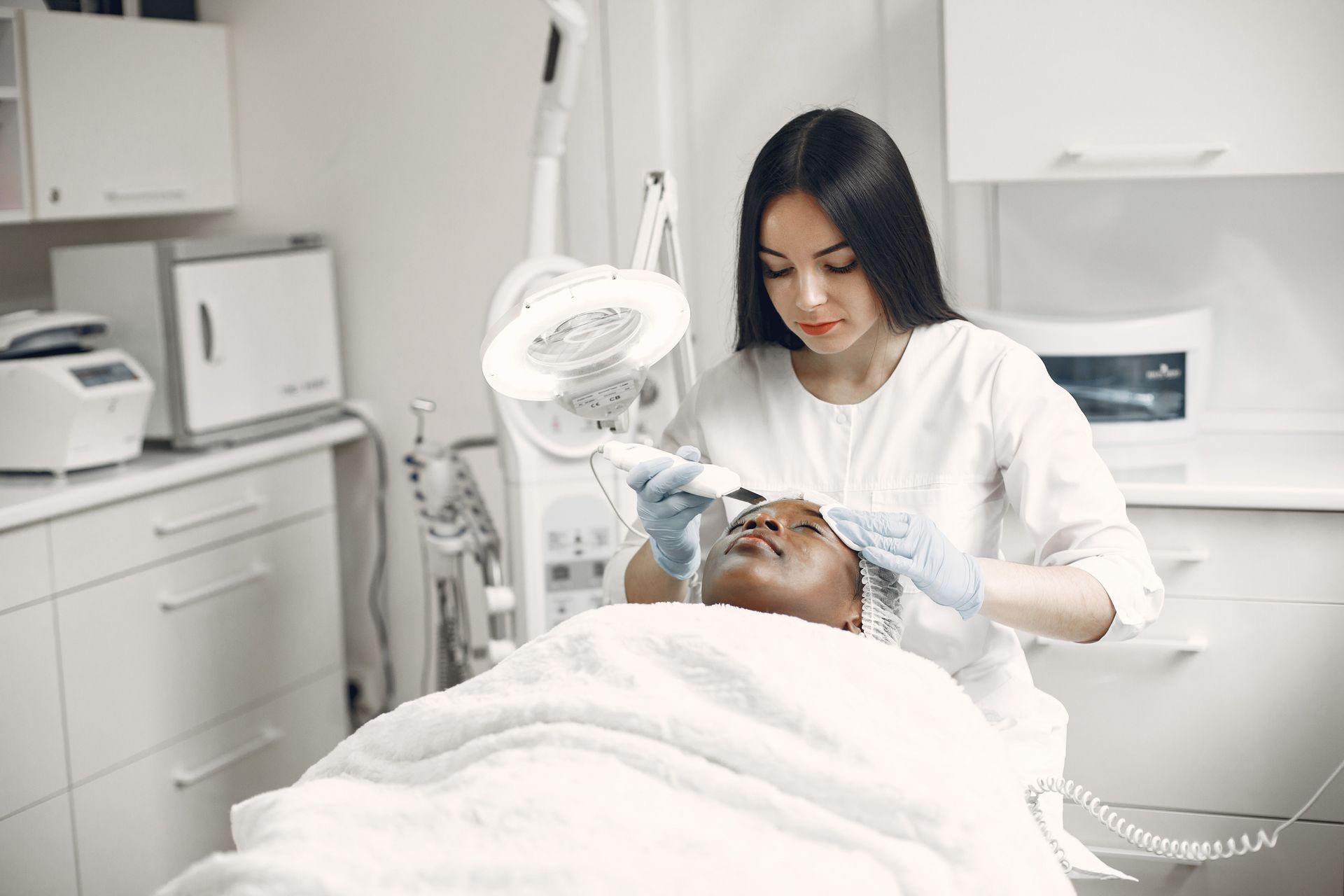 Medical provider consulting with a patient about non-surgical skin tightening treatments and collage