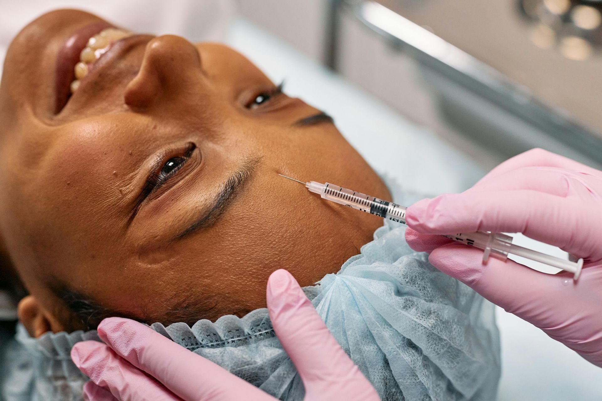 Expert injector at Chronos Body Health & Wellness performing facial balancing treatment with injecta