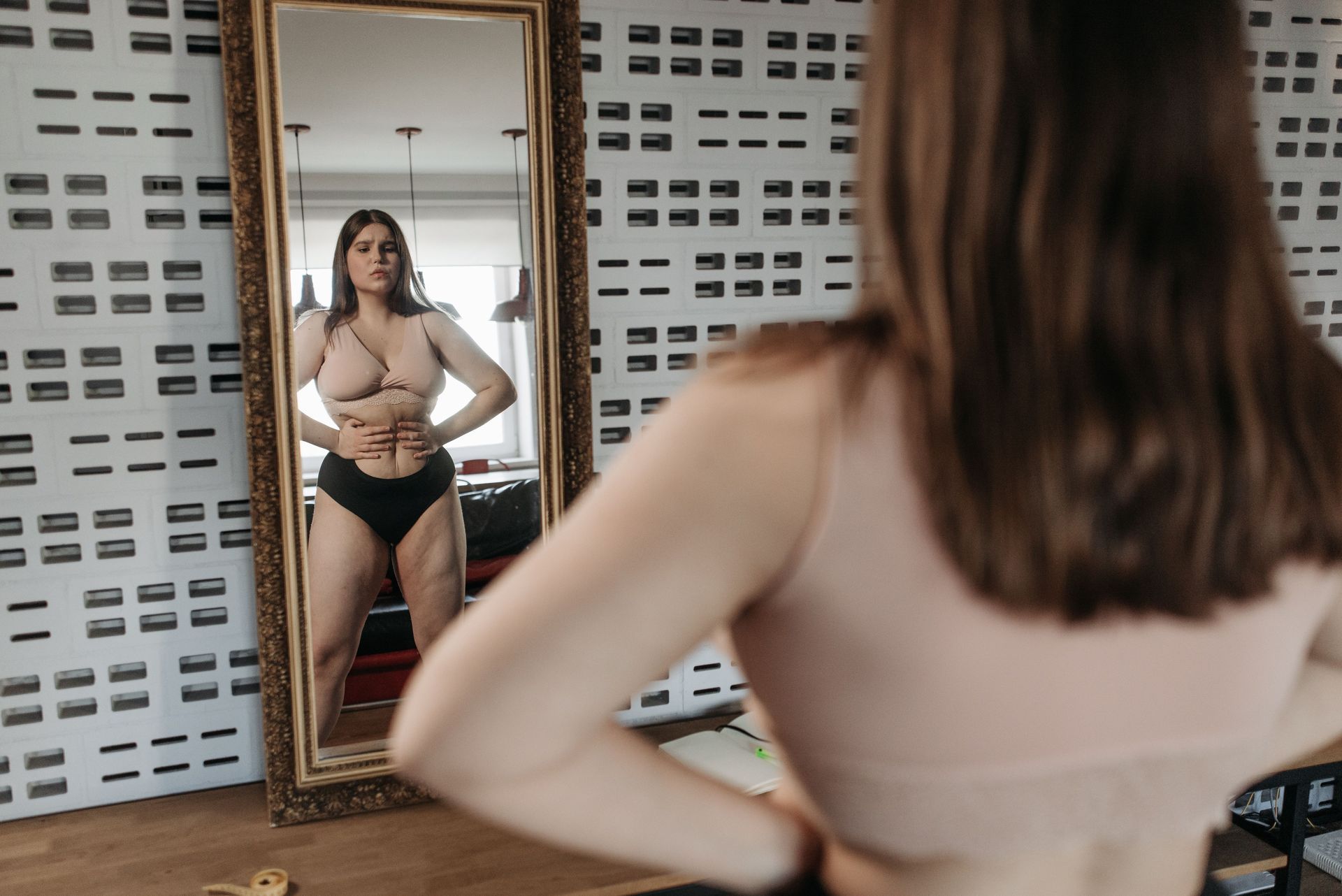 Woman in her 50s experiencing menopausal weight gain and symptoms