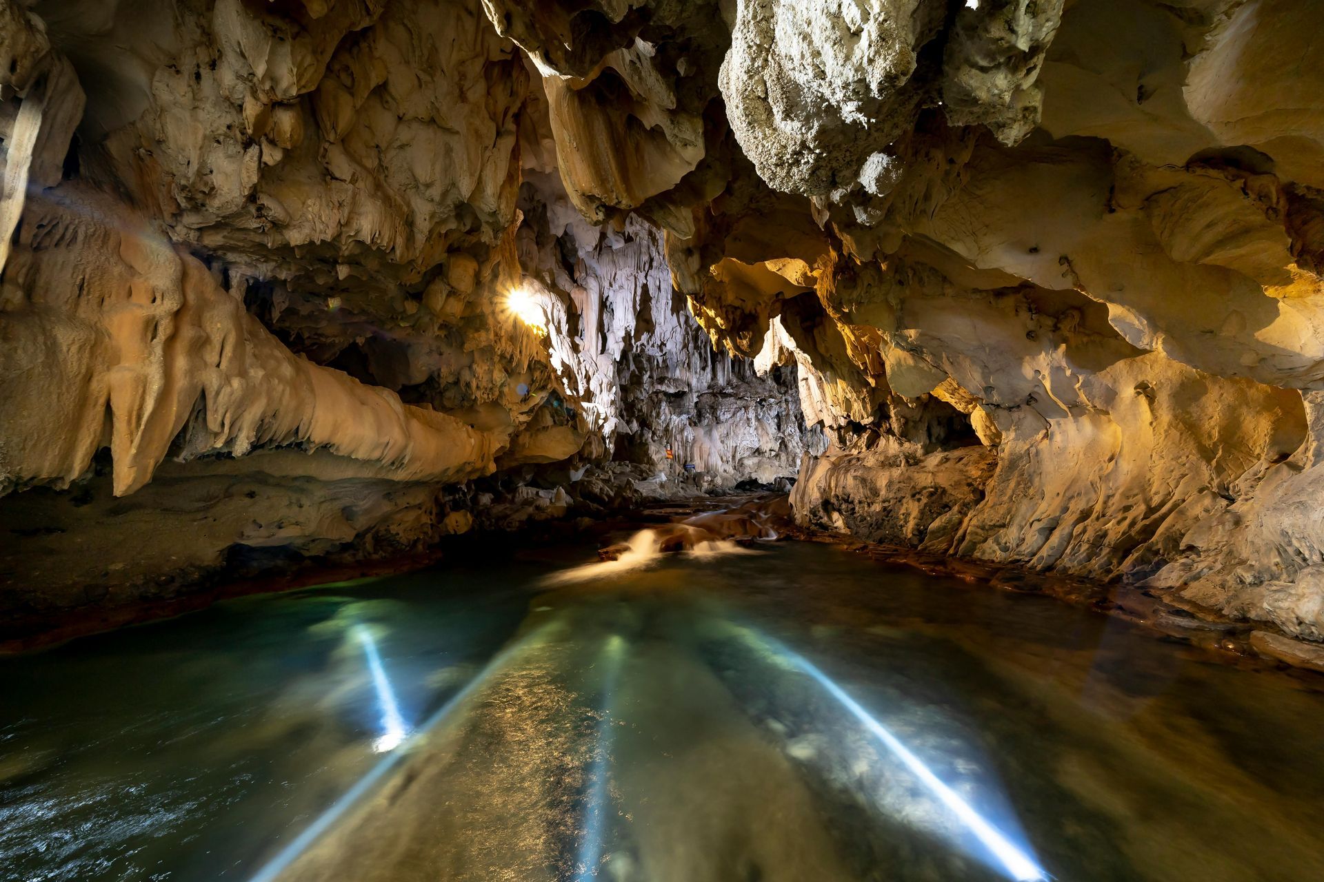 A cave with a river coming out of it