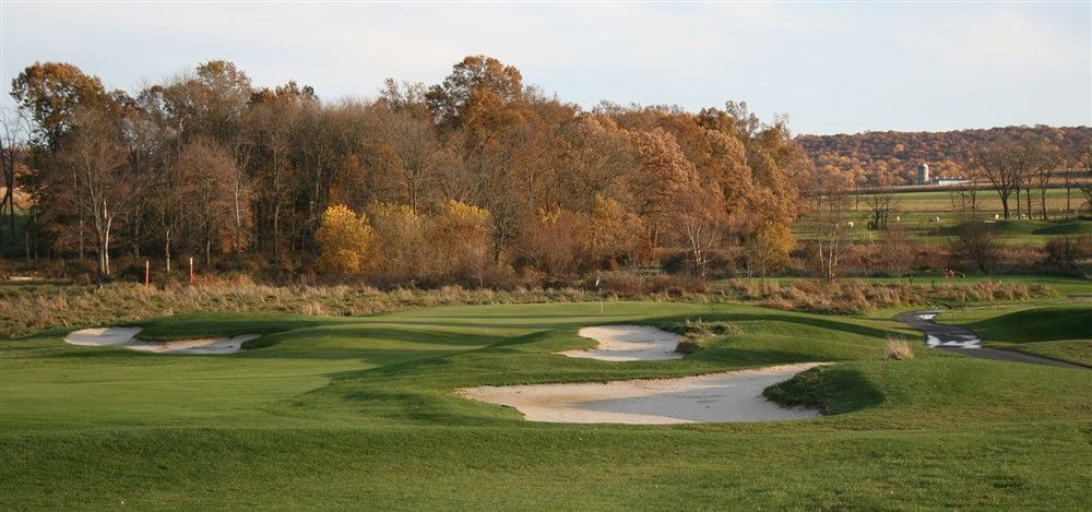A golf course with a lot of trees in the background