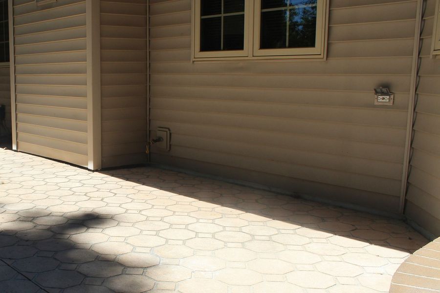 A house with a patio in front of it and a window.