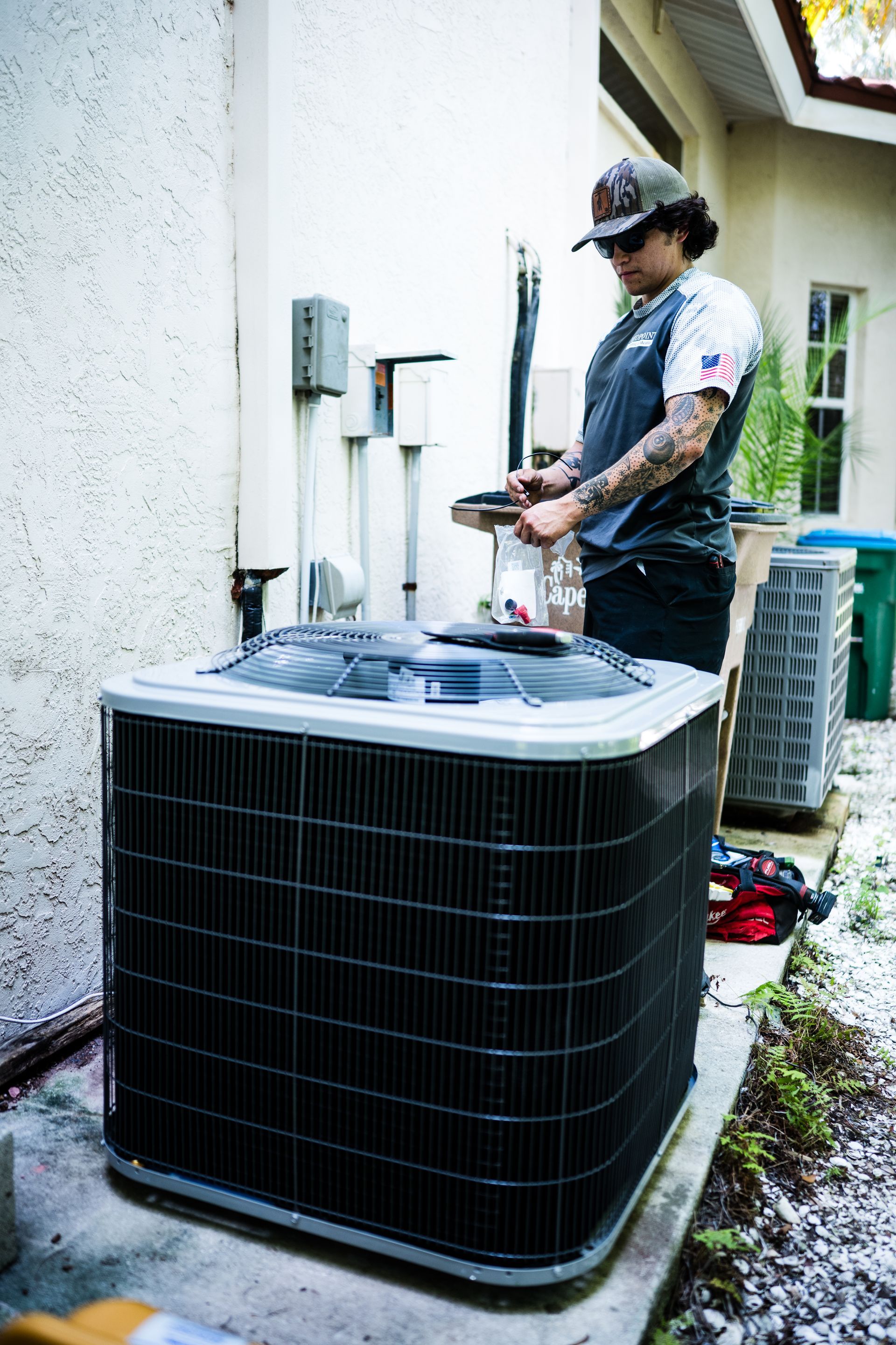 Midpoint Cooling & Heating technician servicing an HVAC system