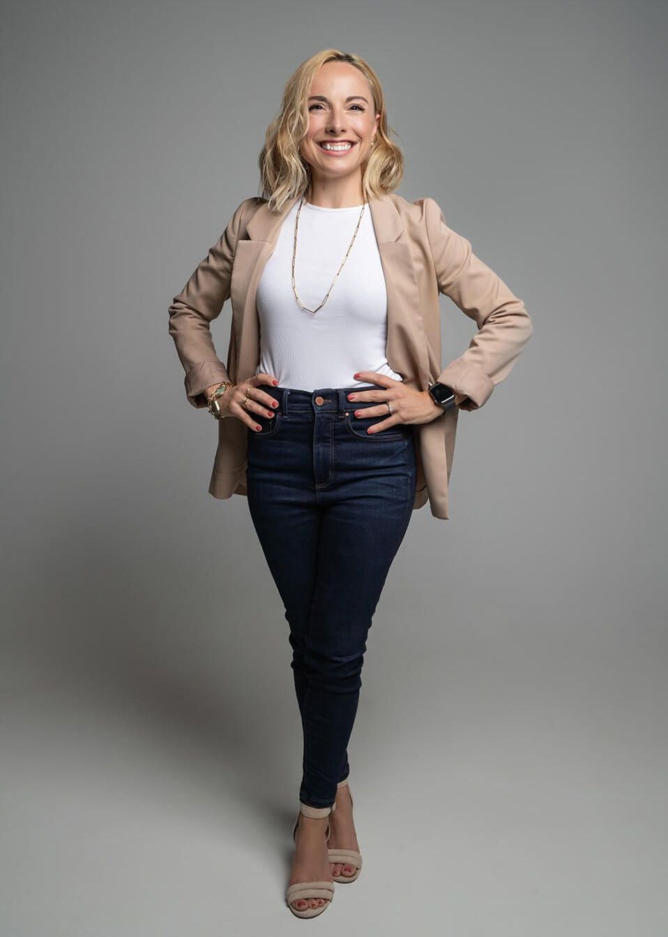 Margaret standing with her hands on her hips and smiling.
