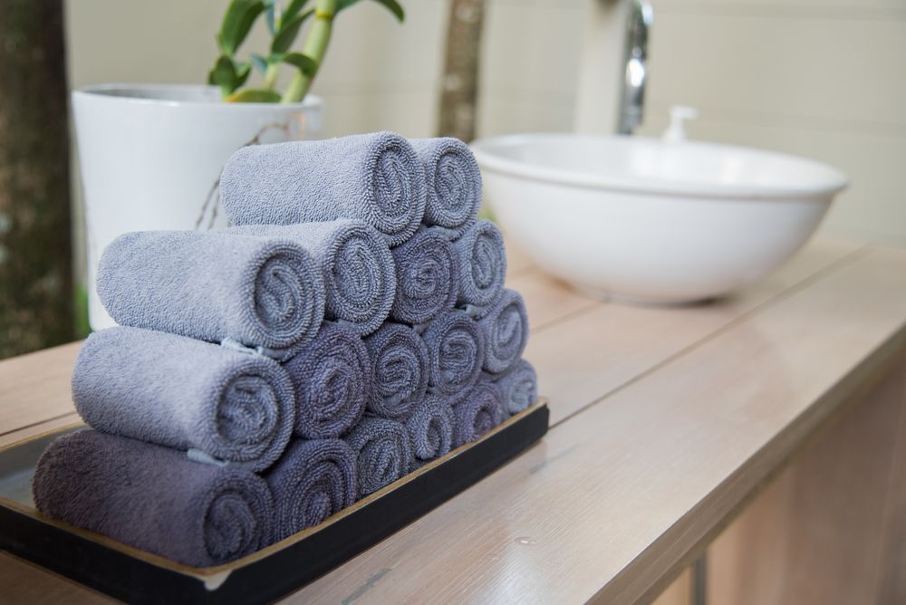 Rolled Hand Towels Stack on a Tray — Gold Coast Linen Hire in Tugun, QLD