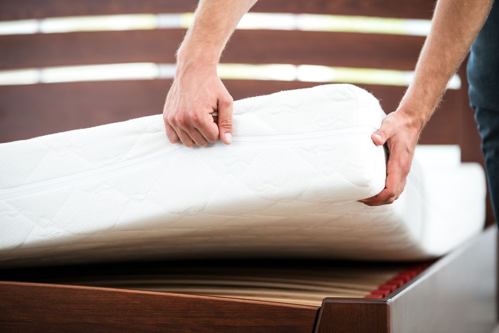 Man Removing the Cover on the Mattress — Gold Coast Linen Hire in Tugun, QLD