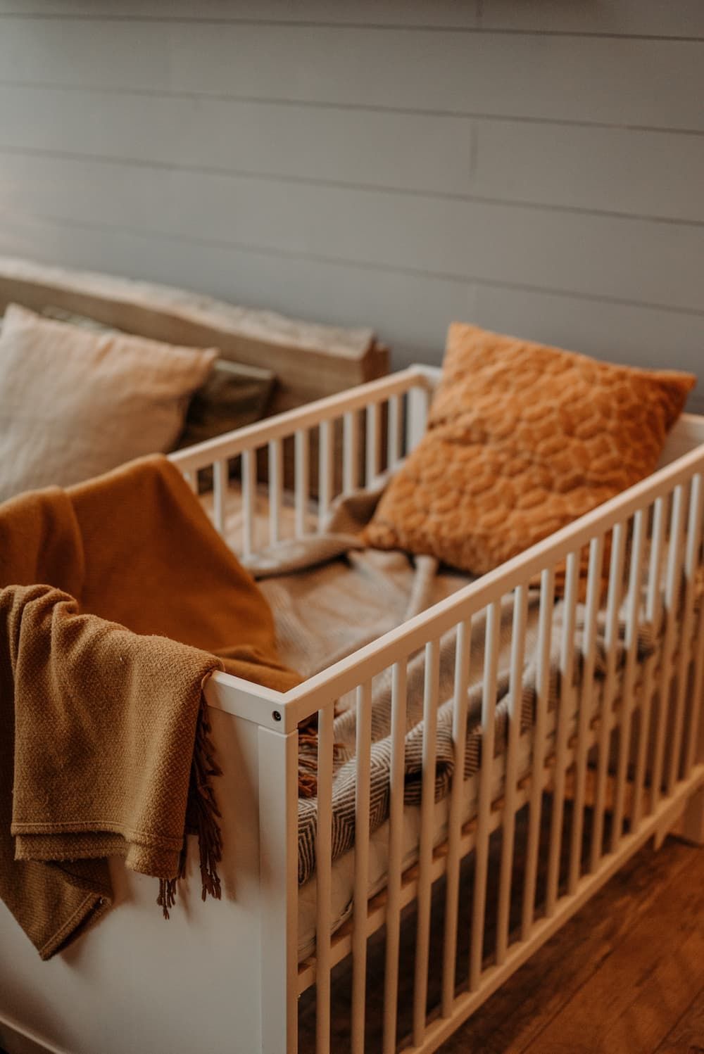White Wooden Cot with Cozy Blanket — Gold Coast Linen Hire in Tugun, QLD