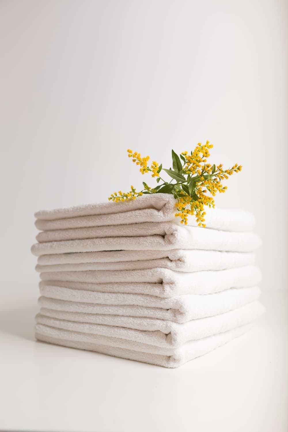Yellow Flower on Top of the Face Towel — Gold Coast Linen Hire in Tugun, QLD