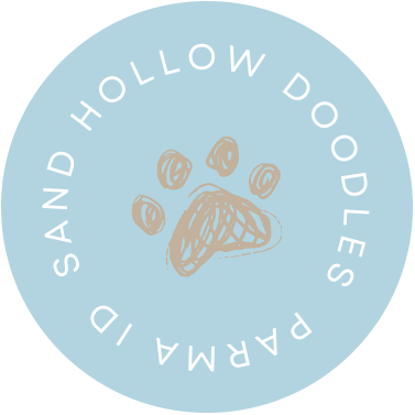 Light blue circular logo with white text and a tan paw print in the center