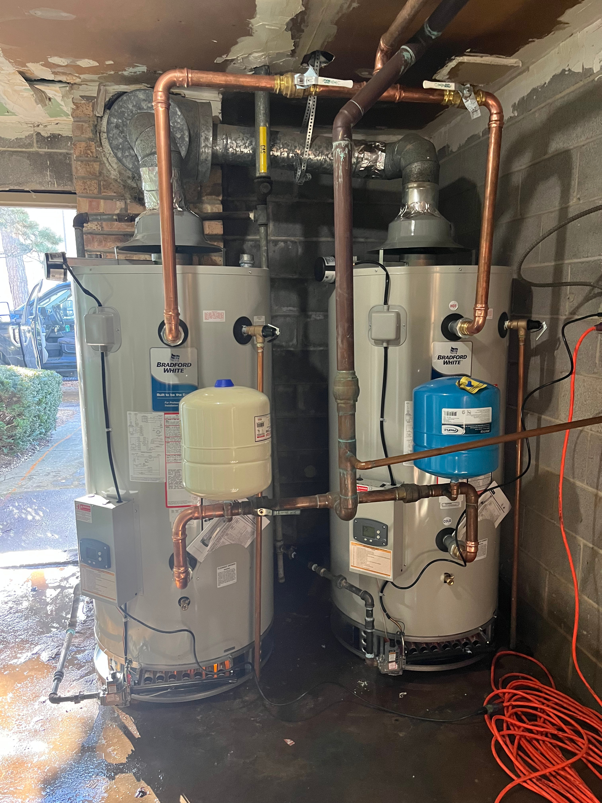 PLACEHOLDER — replace with real H2O photo: water heater installation in progress, residential utility room.