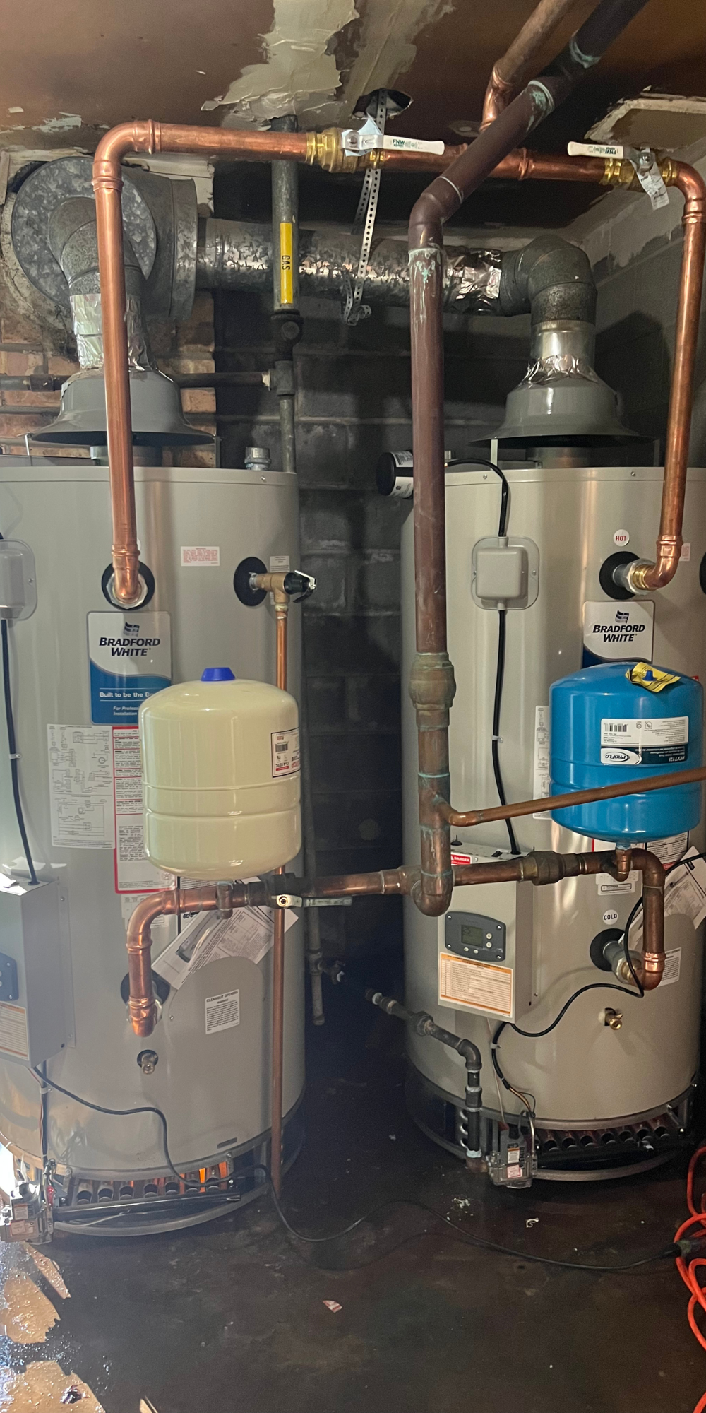 PLACEHOLDER — replace with real H2O job photo: licensed plumber performing emergency repair inside residential utility room.
