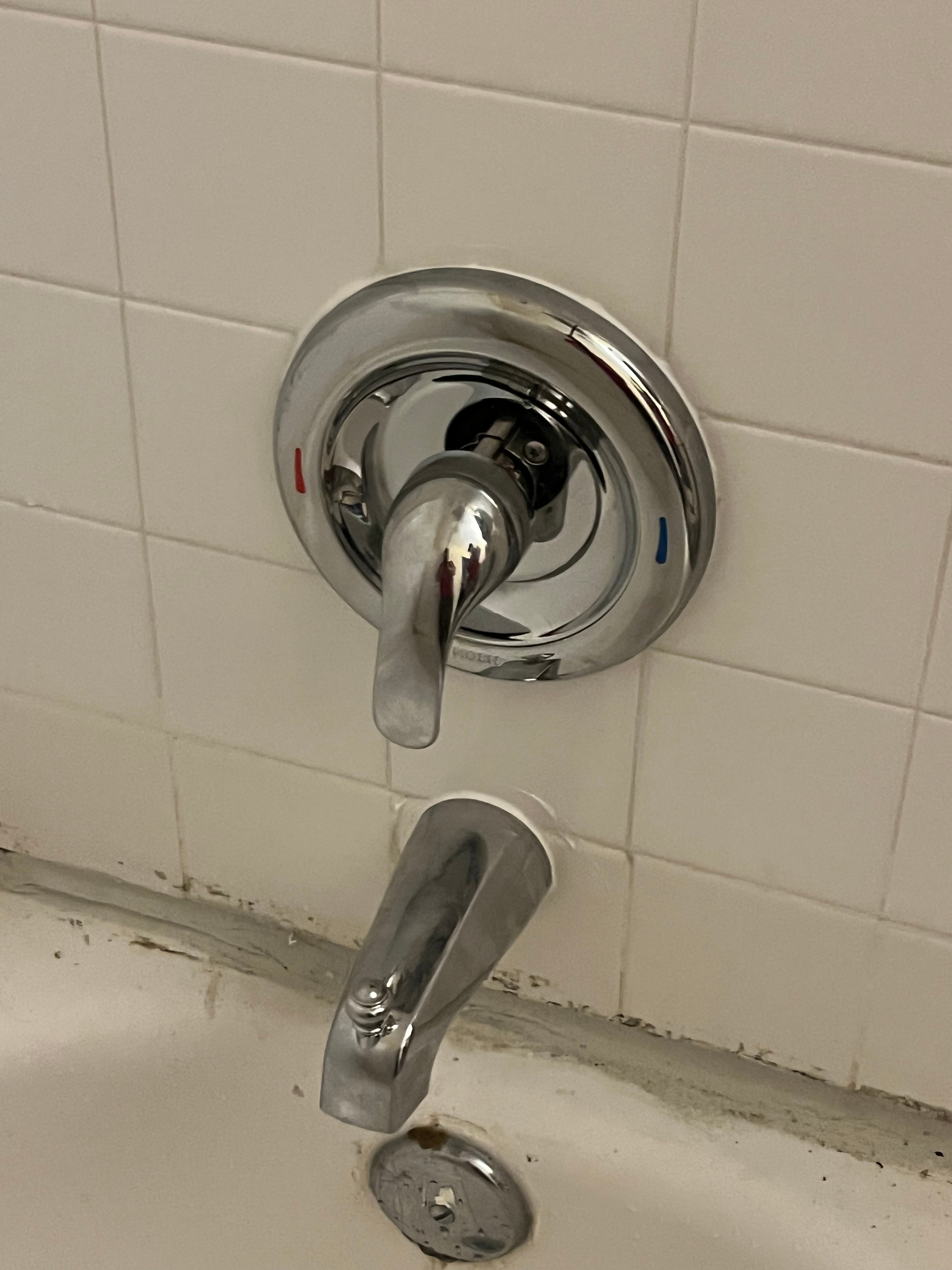 PLACEHOLDER — replace with real H2O technician working on a toilet or shut-off valve, showing careful hands-on workmanship.