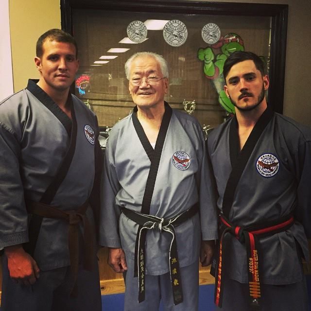a man with a black belt that says karate on it