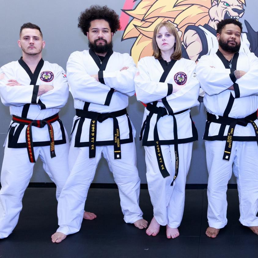 a group of martial arts students pose for a photo