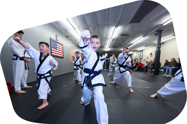 a group of young boys are practicing martial arts in a gym
