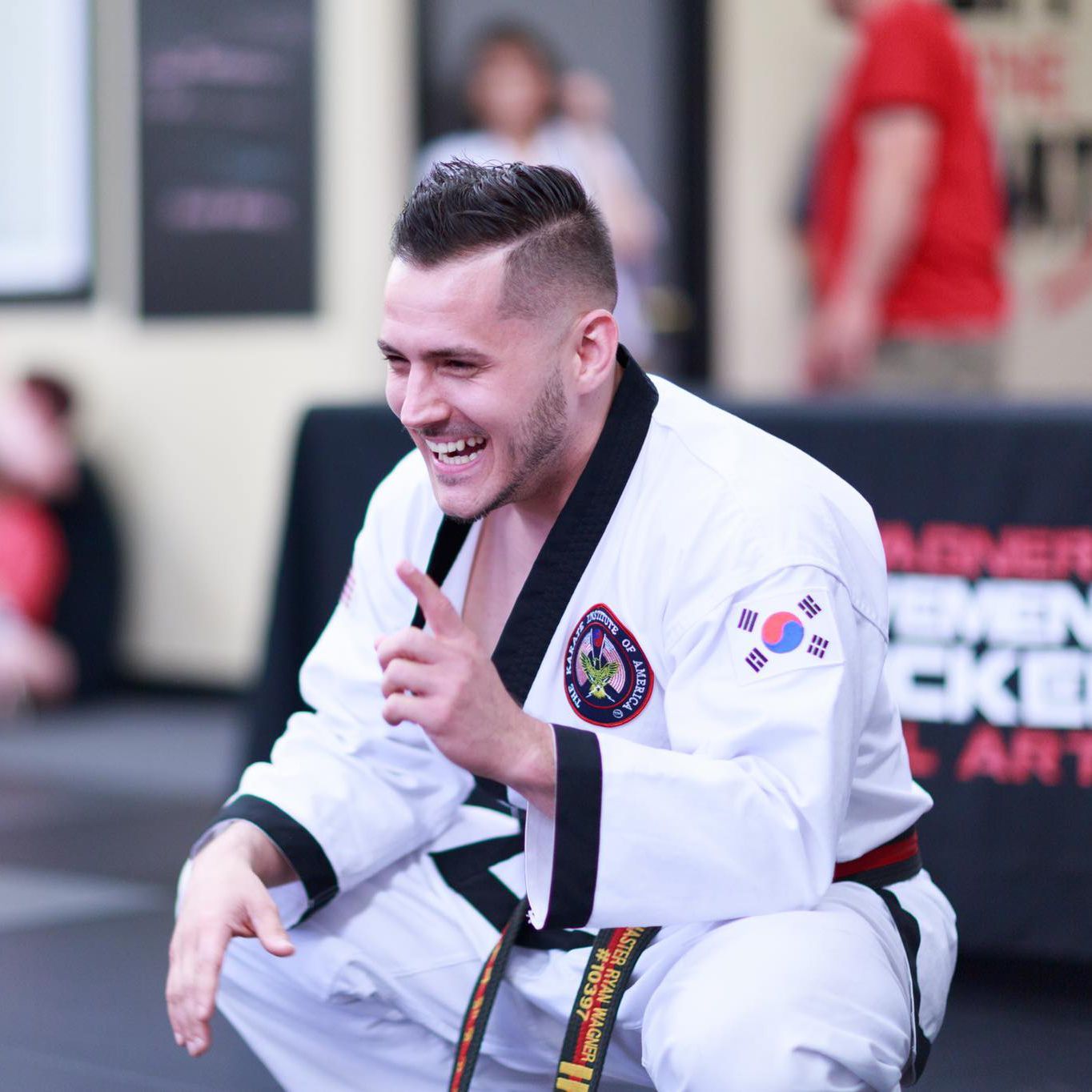 a man in a karate uniform with a korean flag on his chest