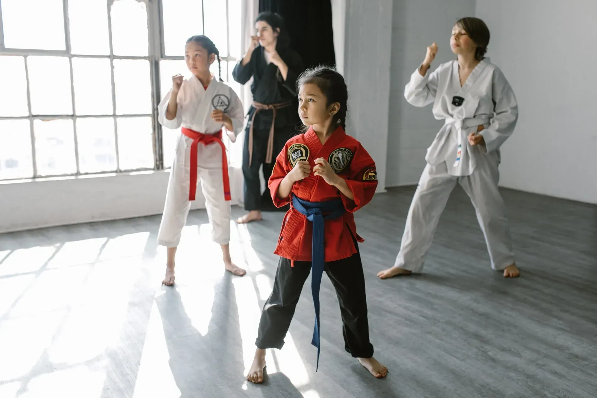 a girl in a red karate uniform
