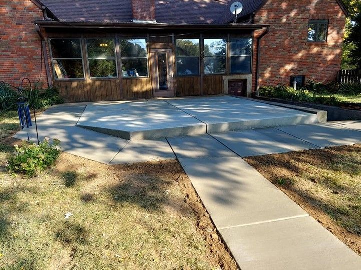 A Brick House With a Concrete Walkway Leading to It - Wentzville, MO - Nelson Concrete & Construction