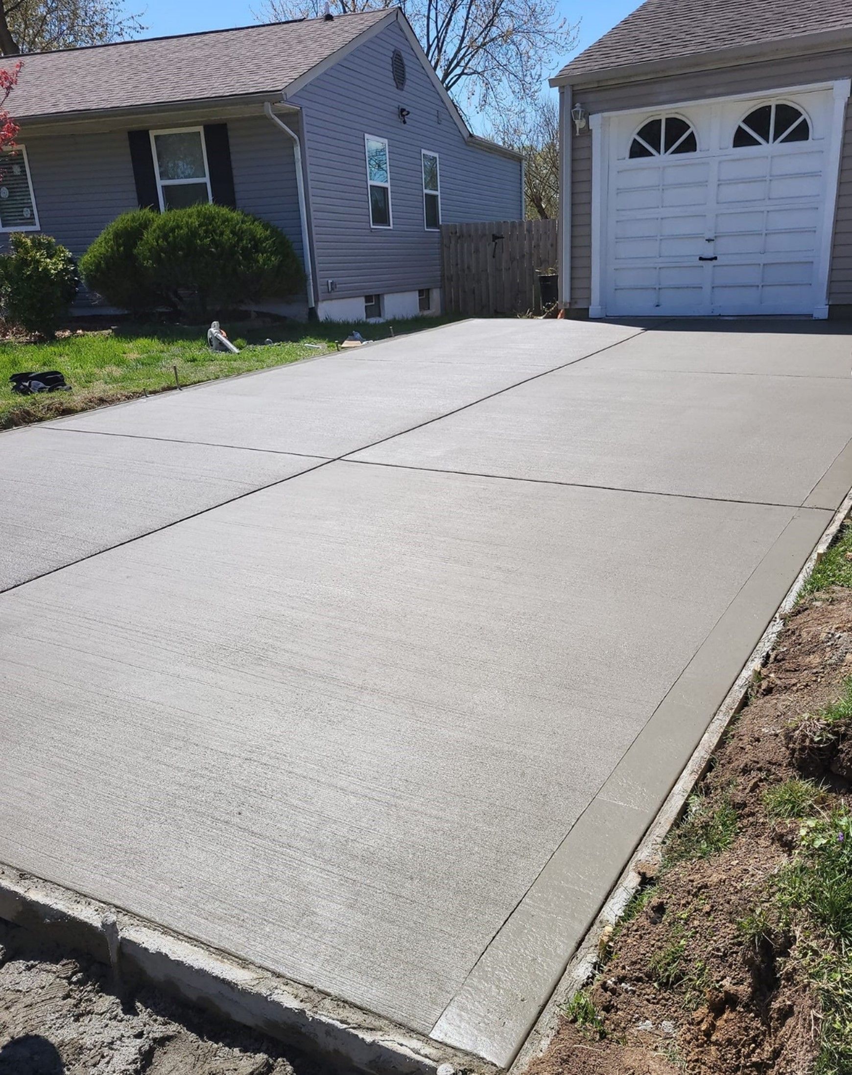 A Concrete Driveway Near Garage - Wentzville, MO - Nelson Concrete & Construction