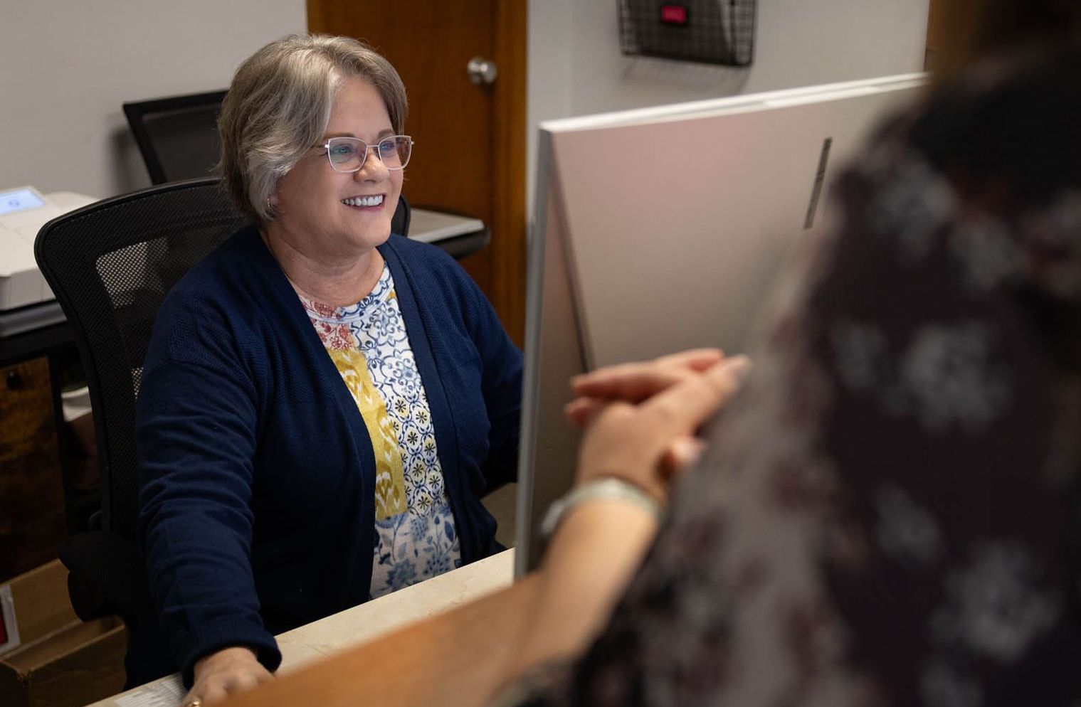 Patient Care Representative greeting patient. Patient Care Representative greeting patient.