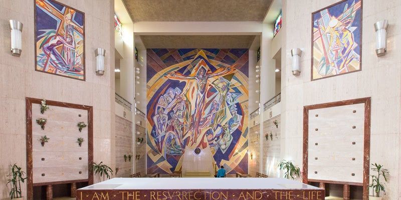 Colorful abstract mural in a bright hallway with framed panels on both walls