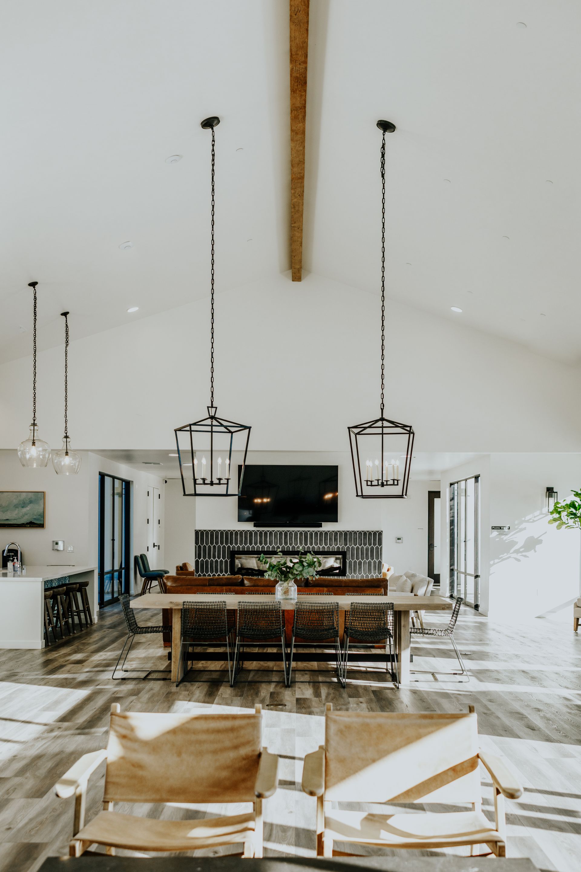 A living room with chairs , a table and a fireplace.