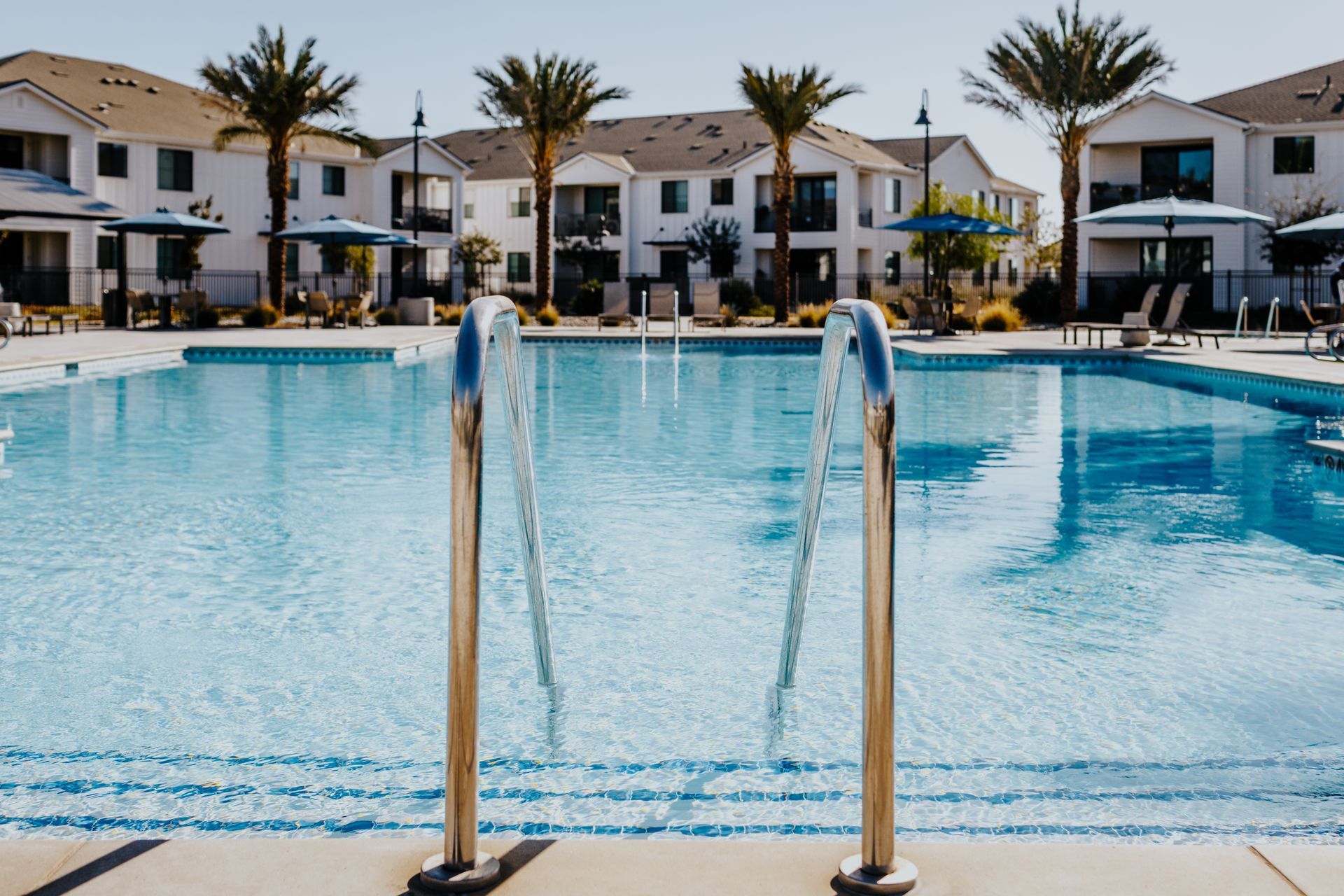 A large swimming pool with stairs leading to it