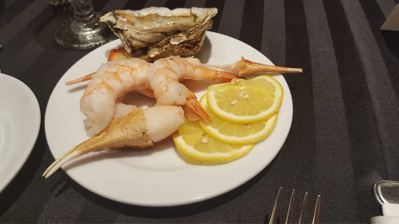 Grilled steak and shrimp with lemon wedge.