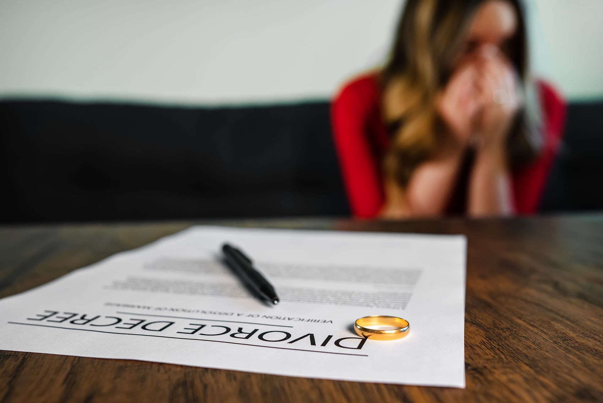 A gold ring and pen rest on a document titled