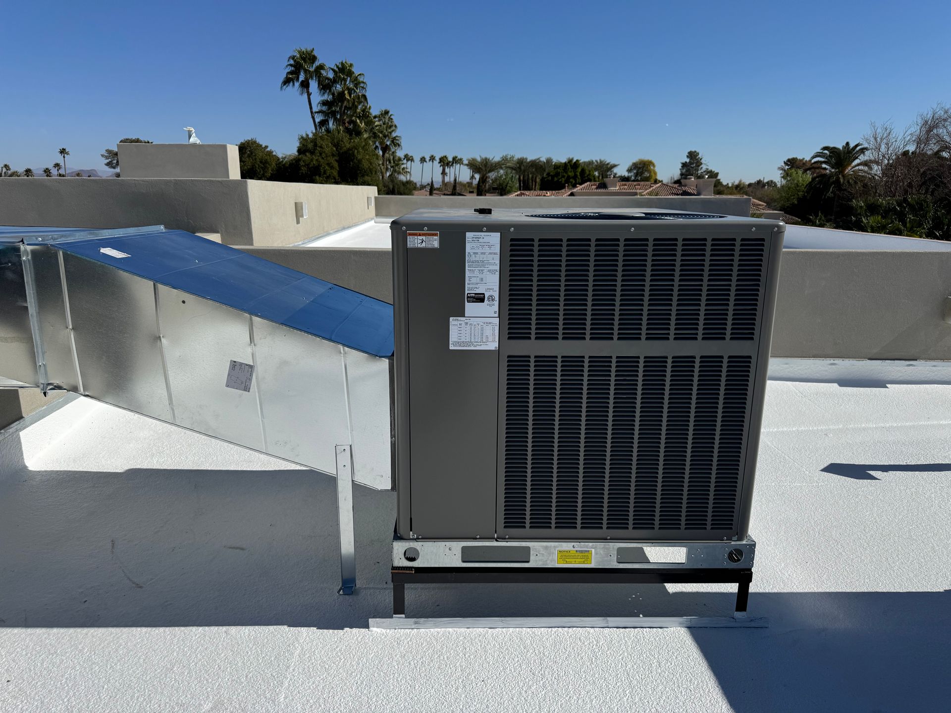 An air conditioner is sitting on the roof of a building