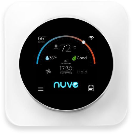 A white thermostat with a black screen is sitting on a white surface.