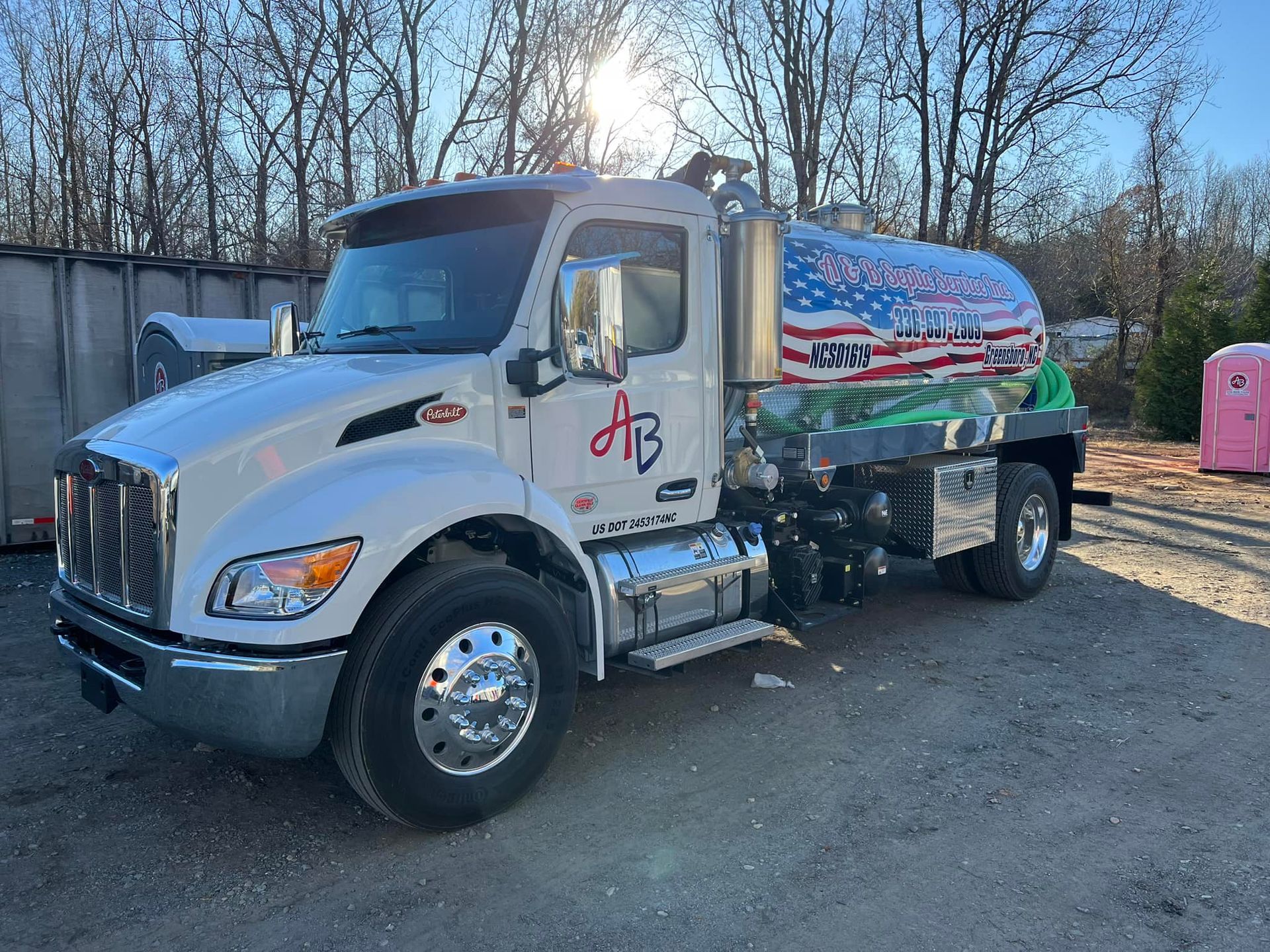 A white tank truck with American flag decals and 